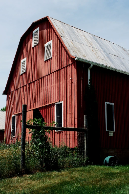 the farm barn sits empty on a sunny day