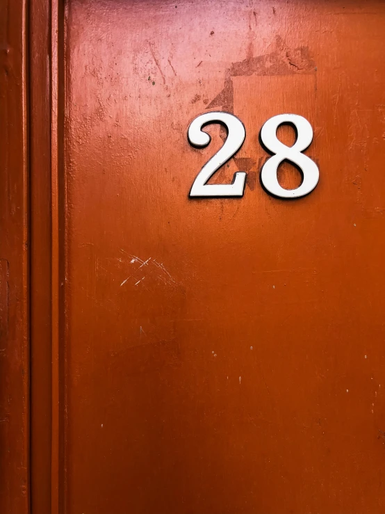 a number twenty is displayed on a brown door