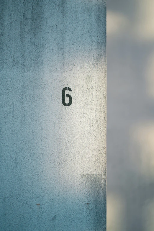 an odd picture of a blue wall with the number five