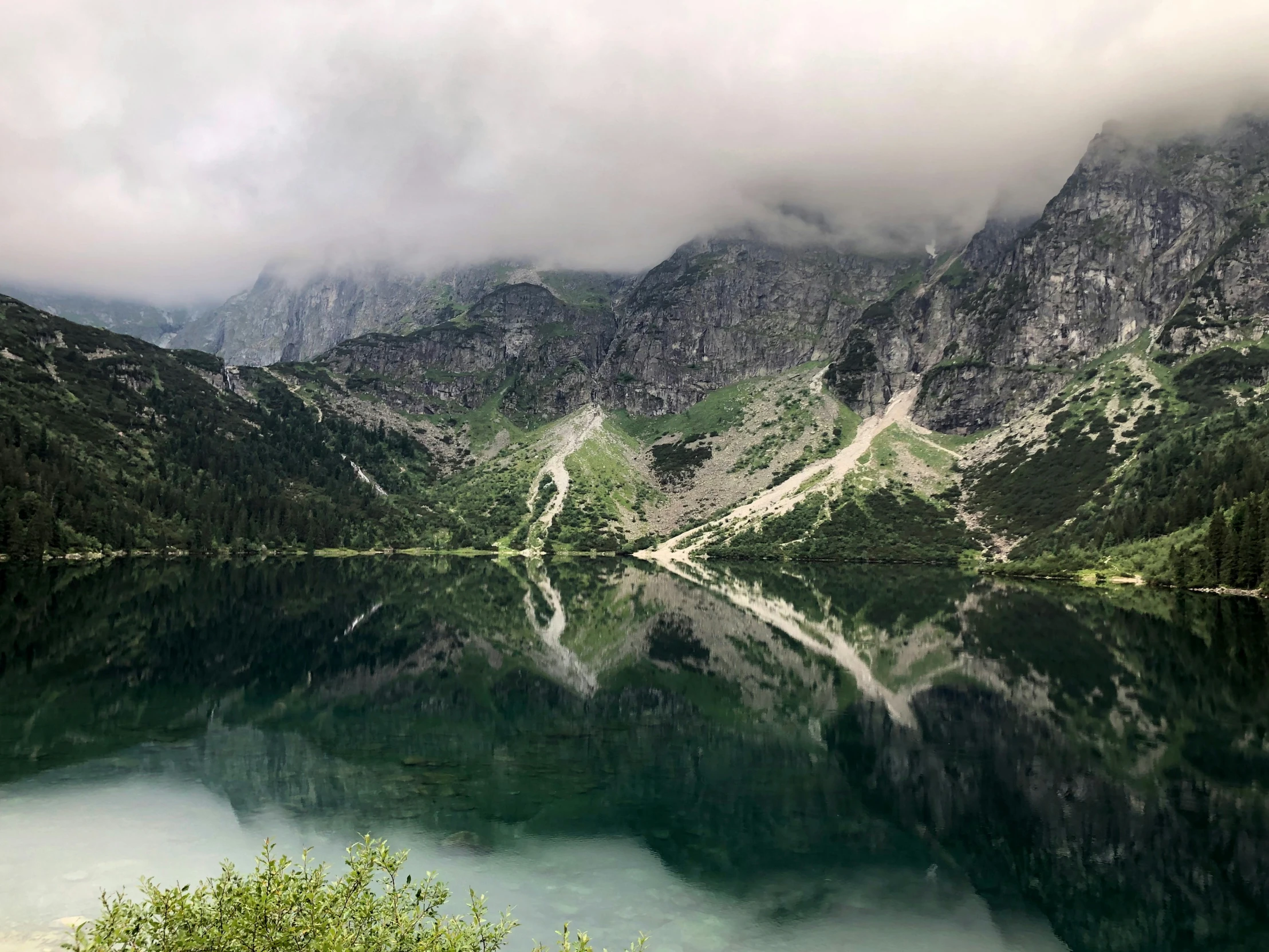 a po taken from an overlook overlooking a lake with mountains in the background