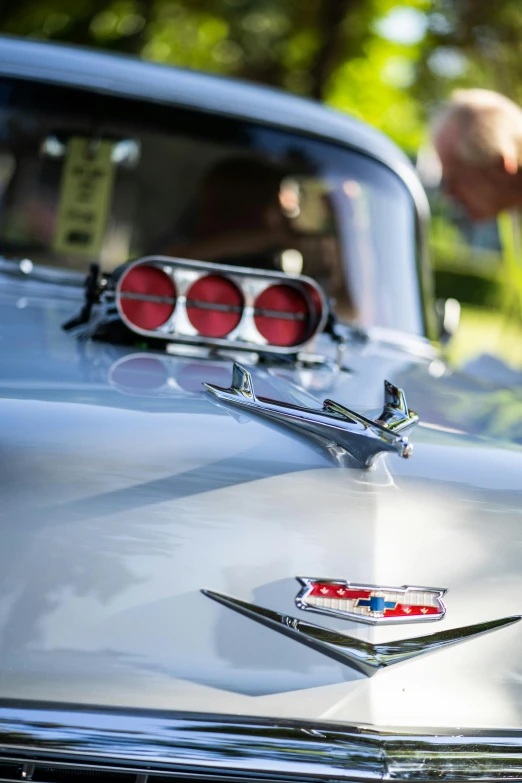 an old chevrolet hood ornament at an automobile show