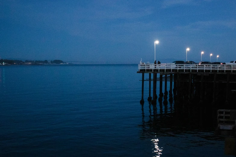 there are many lights on the side of the pier