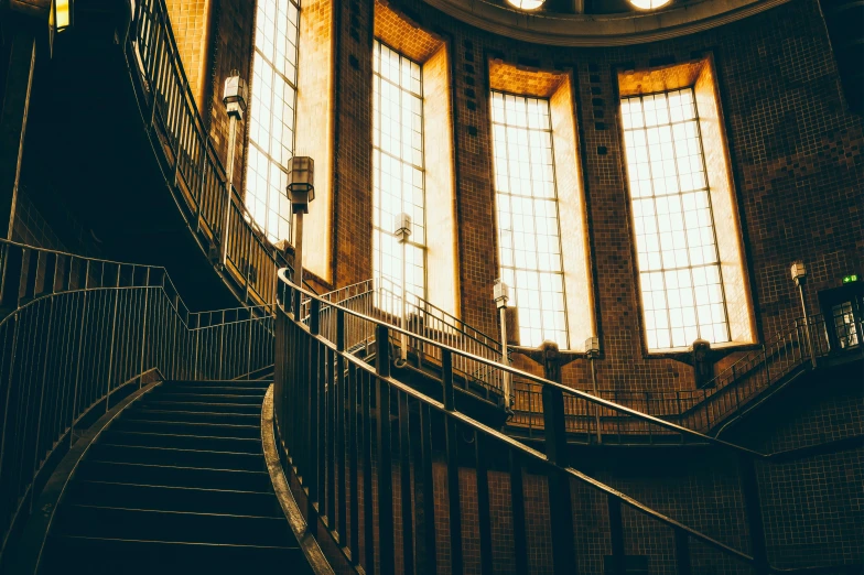 an empty stairway with windows and light coming in from the top of them