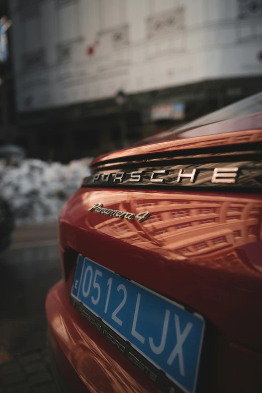 a red car sitting on the side of a road