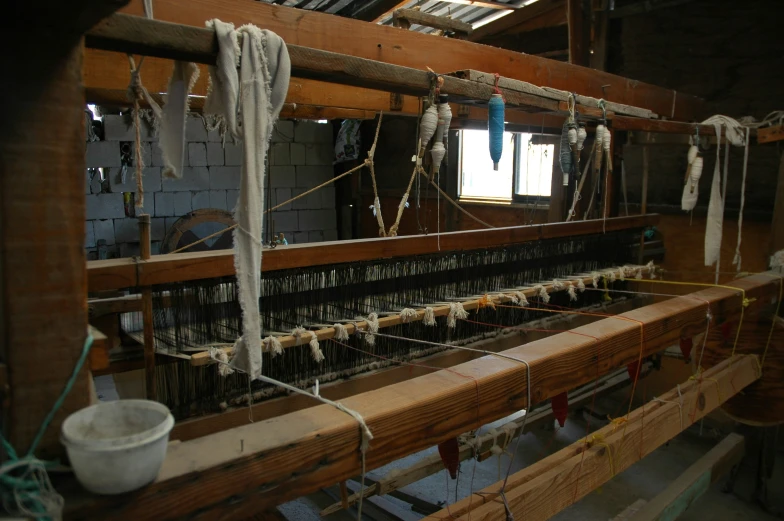 a long wooden loom with a few different ropes