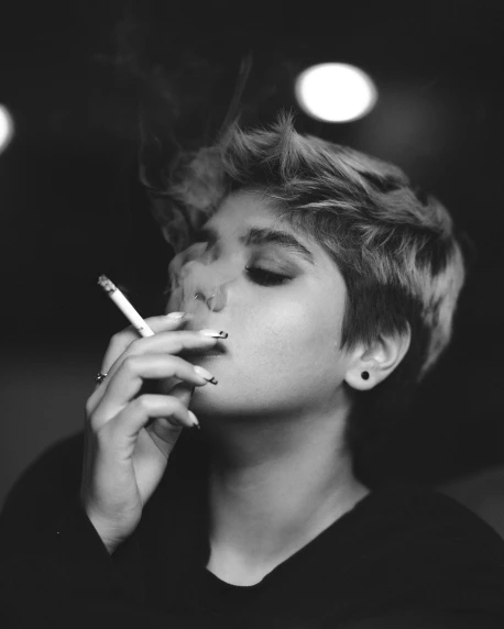 a black and white po of a woman smoking