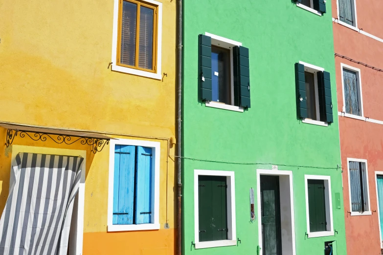 colorfully painted buildings near each other with shutters