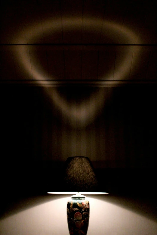 a lamp shining on a dark and creepy background