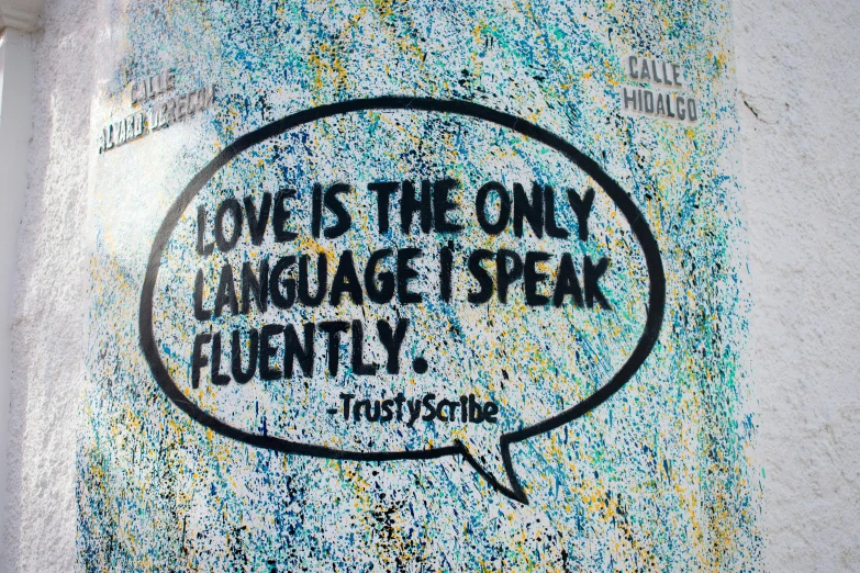 graffiti saying love is the only language speak fluently