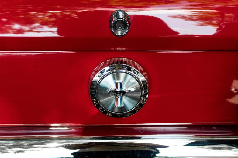 red car with chrome wheel hubs, showing the badge and number one