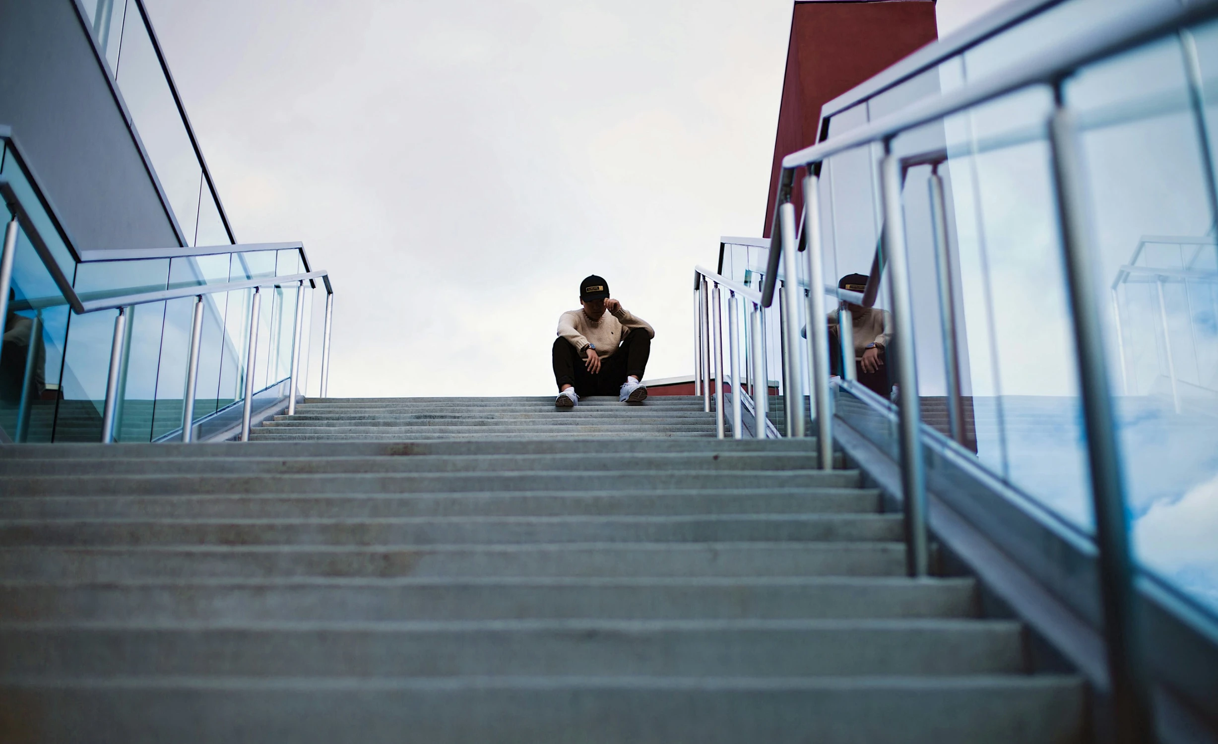 a person sitting on some steps looking down at soing