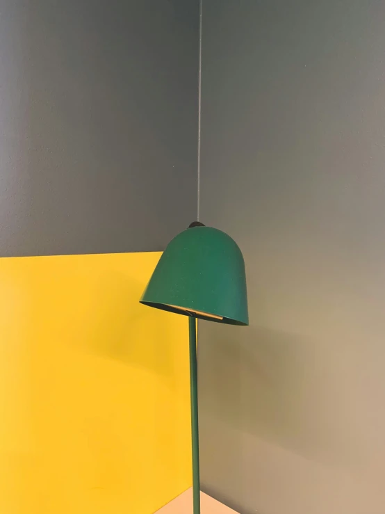 a lamp in front of two walls in a corner