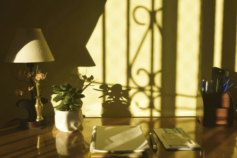 a desk with a lamp and notepad on it