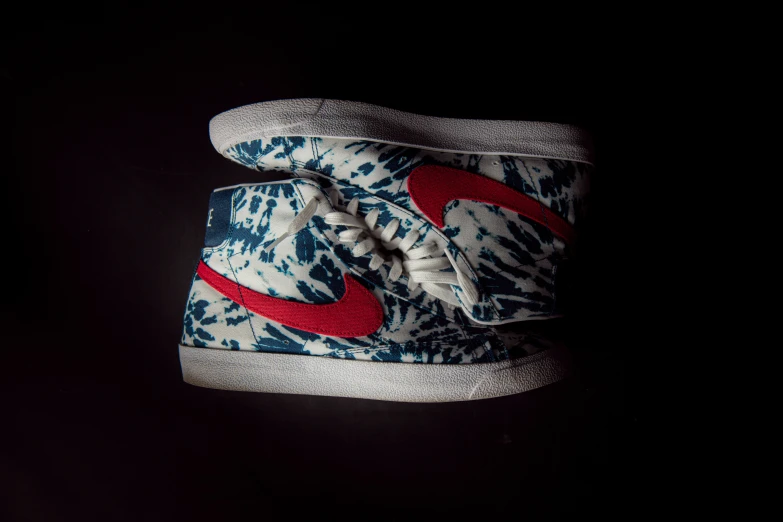 this sneaker is decorated with red, white, and blue paint