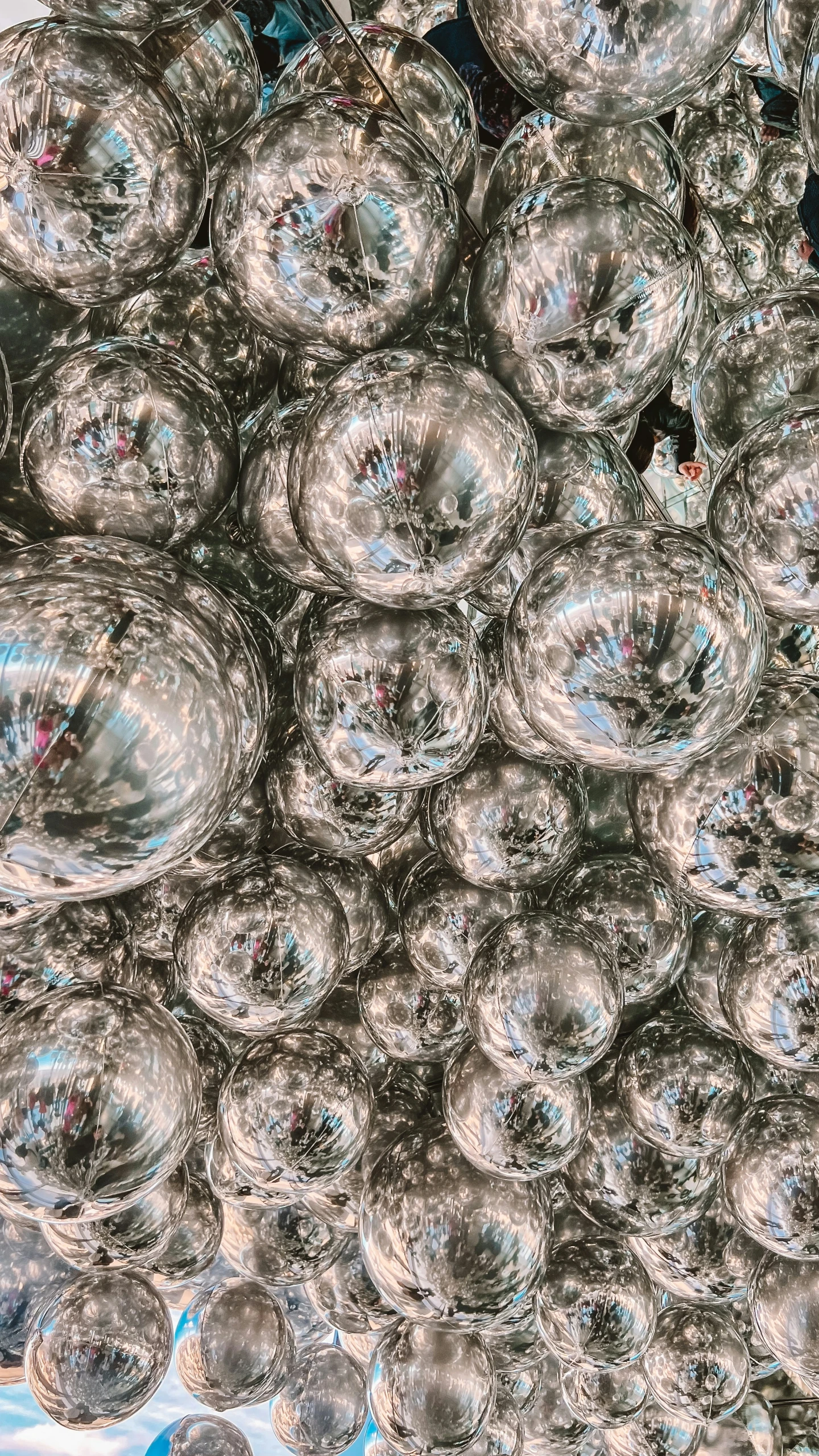 many clear bubbles sitting on a blue surface