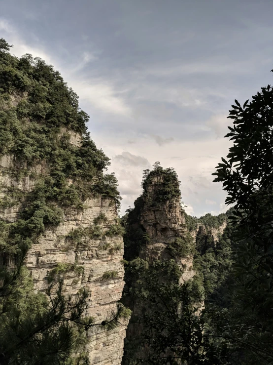 mountains with trees are in the foreground on the other side of the wall