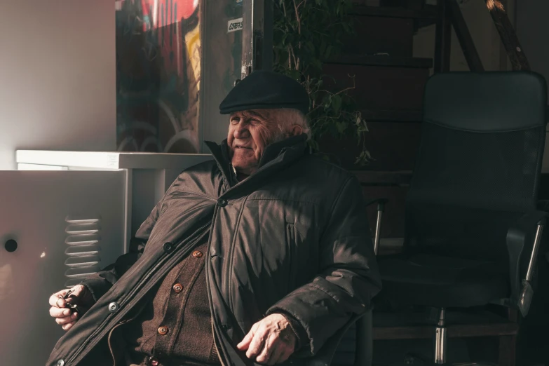 a person sitting in a chair wearing a hat