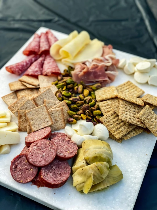 a table with food on it including ham, ers and nuts