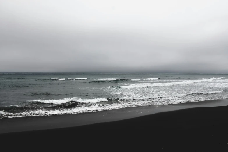 some surfers on the beach with their surfboards