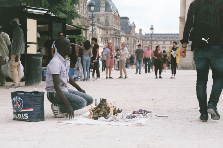 a woman is sitting on the ground by a cake