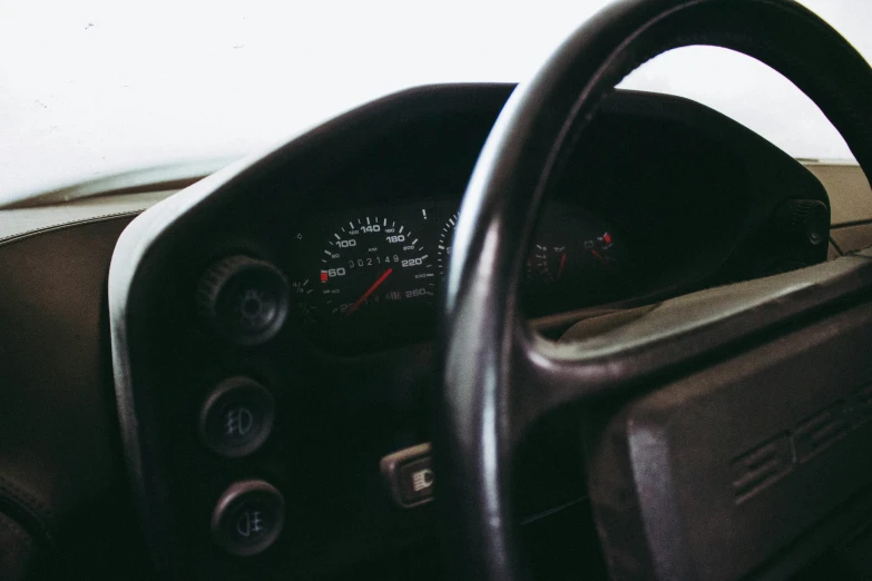 a dashboard and driver's wheel with gauges showing