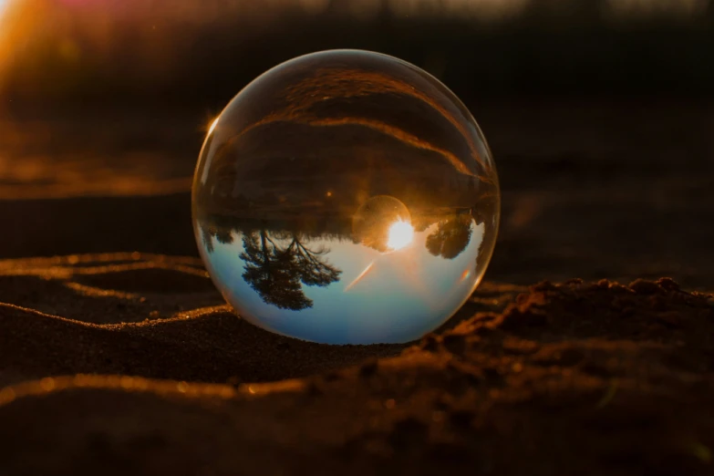 a glass ball sitting on top of dirt