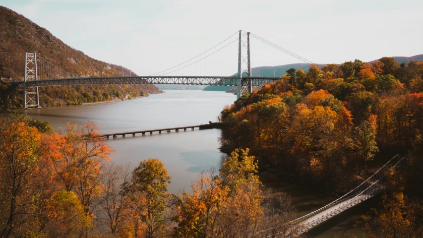 the large bridge is crossing the long bridge over water