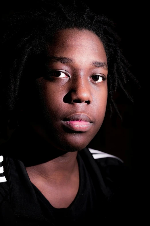 a black woman wearing a jersey stares at the camera