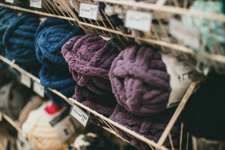 colorful wool items are for sale on racks