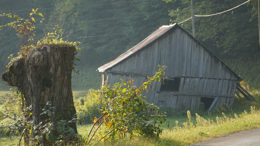 a wooden building sitting on the side of a road