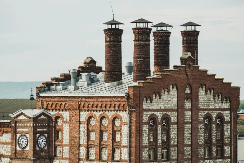 an old brick building with lots of windows and a clock