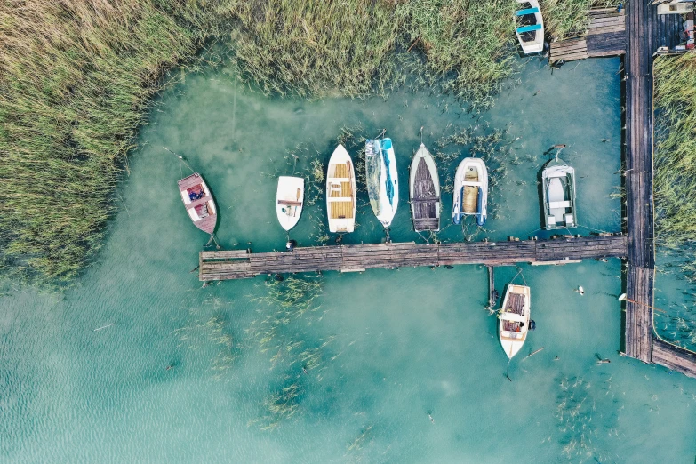 a pier that has some small boats docked to it