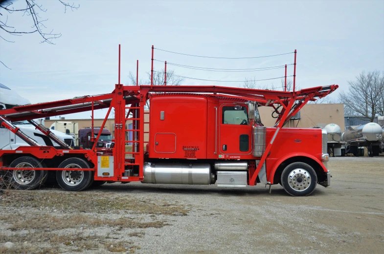 a truck is red with a lift attached