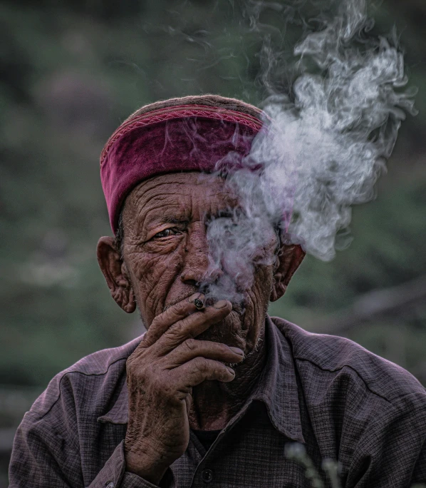 a man in a turban smoking a cigar