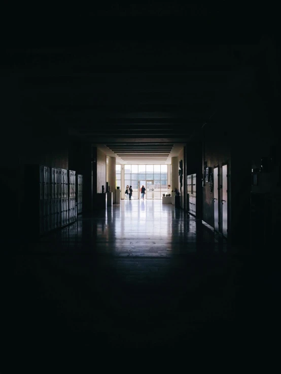 a darkened hallway leads up to two doors