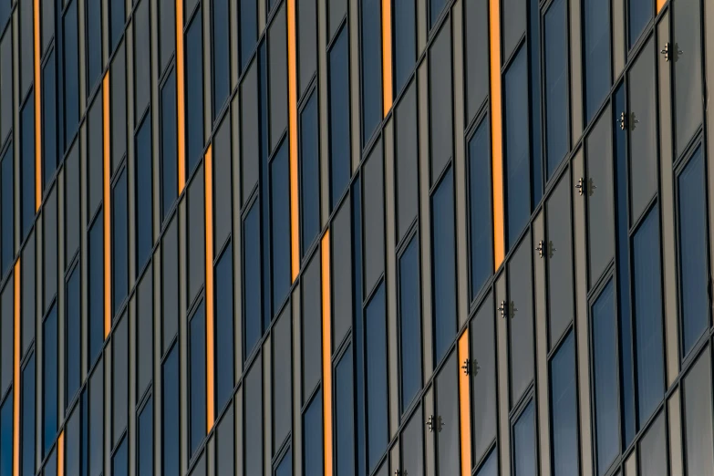 close up of the window on a tall building with blue windows