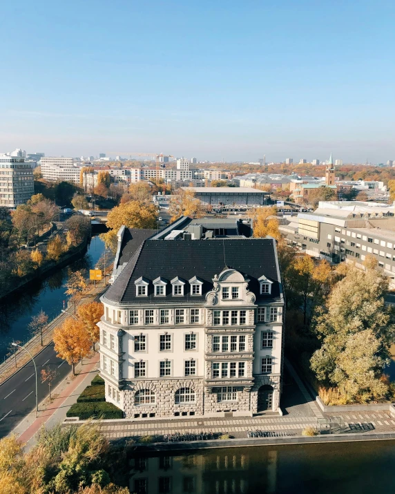 an aerial view of a building with trees around