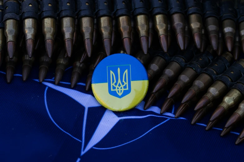 a blue and yellow badge surrounded by some bullet like items