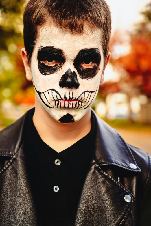 a  wearing white and black skull make up