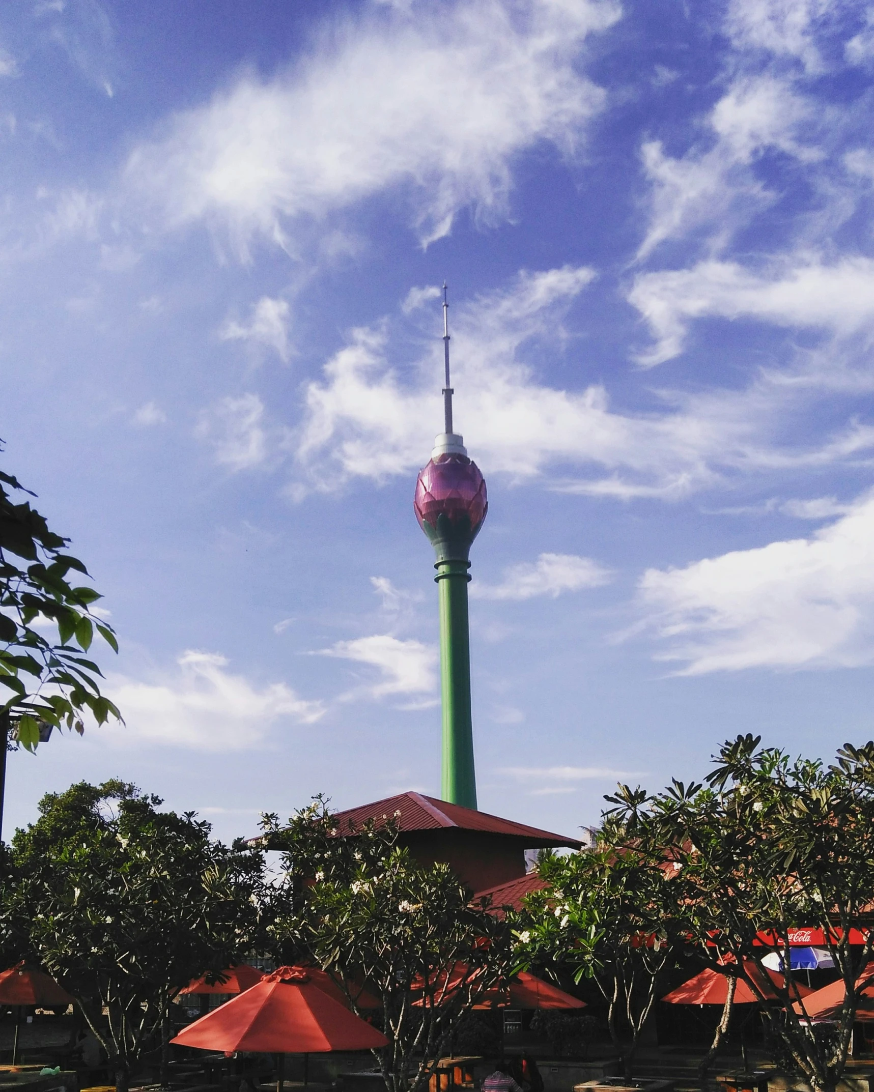 a tall tower with a very green top