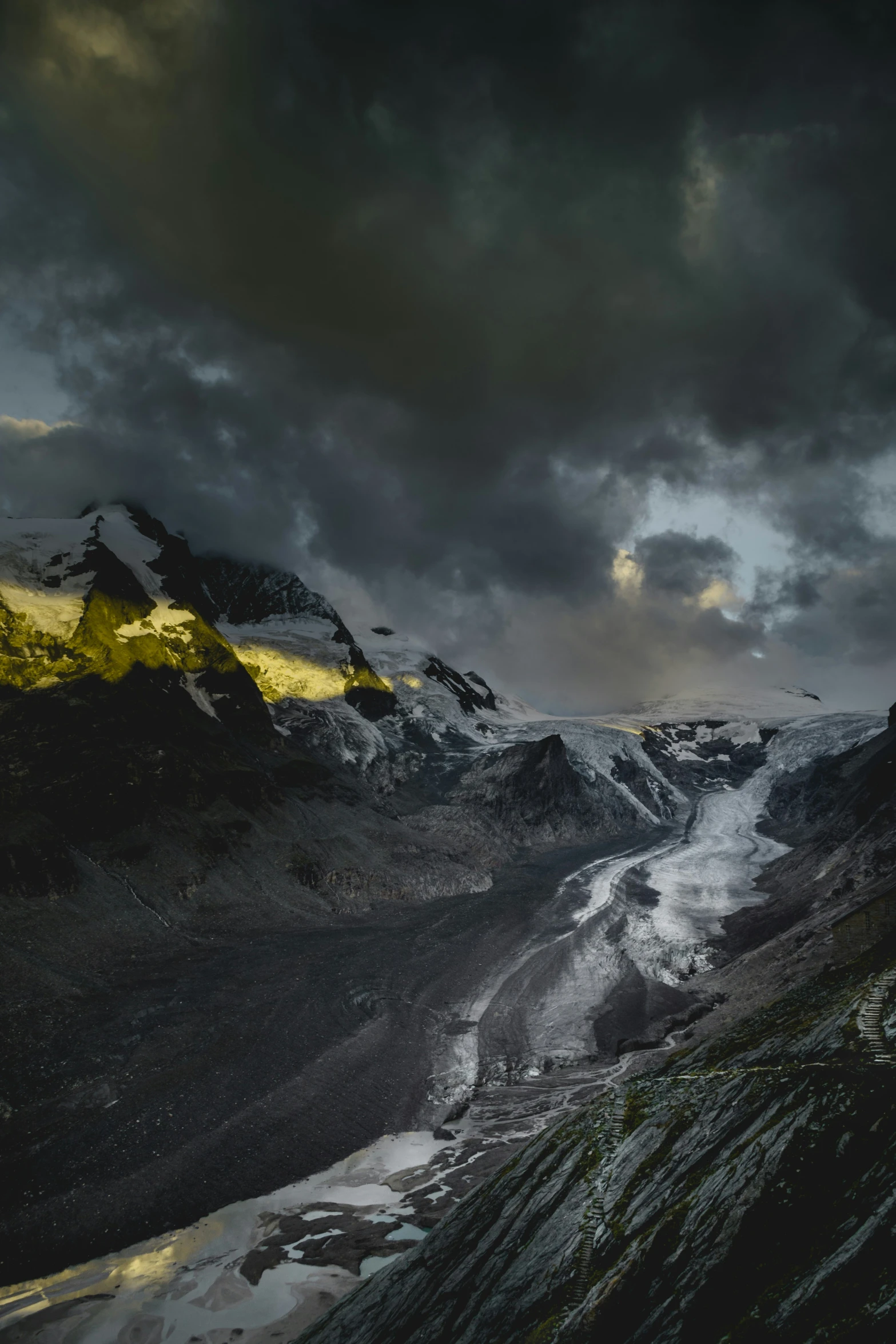 the snow capped mountains are dotted with snow as dusk begins