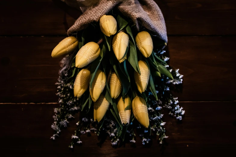 yellow flowers and green leaves on wood