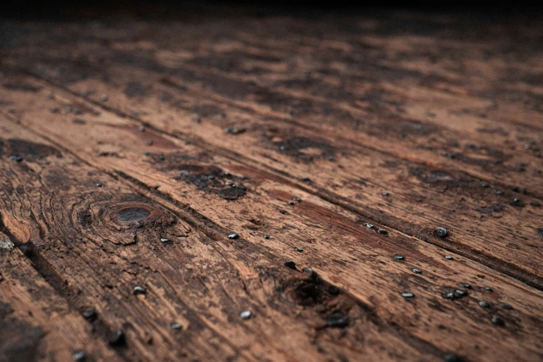 a wooden surface is full of many small drops of water