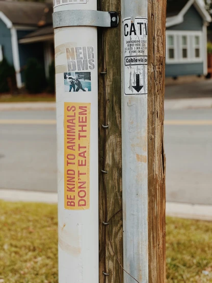 old water tank attached to telephone poles with stickers
