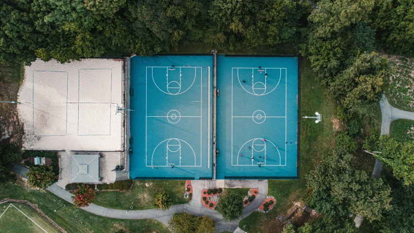an overhead view of a swimming pool that has a basketball court inside
