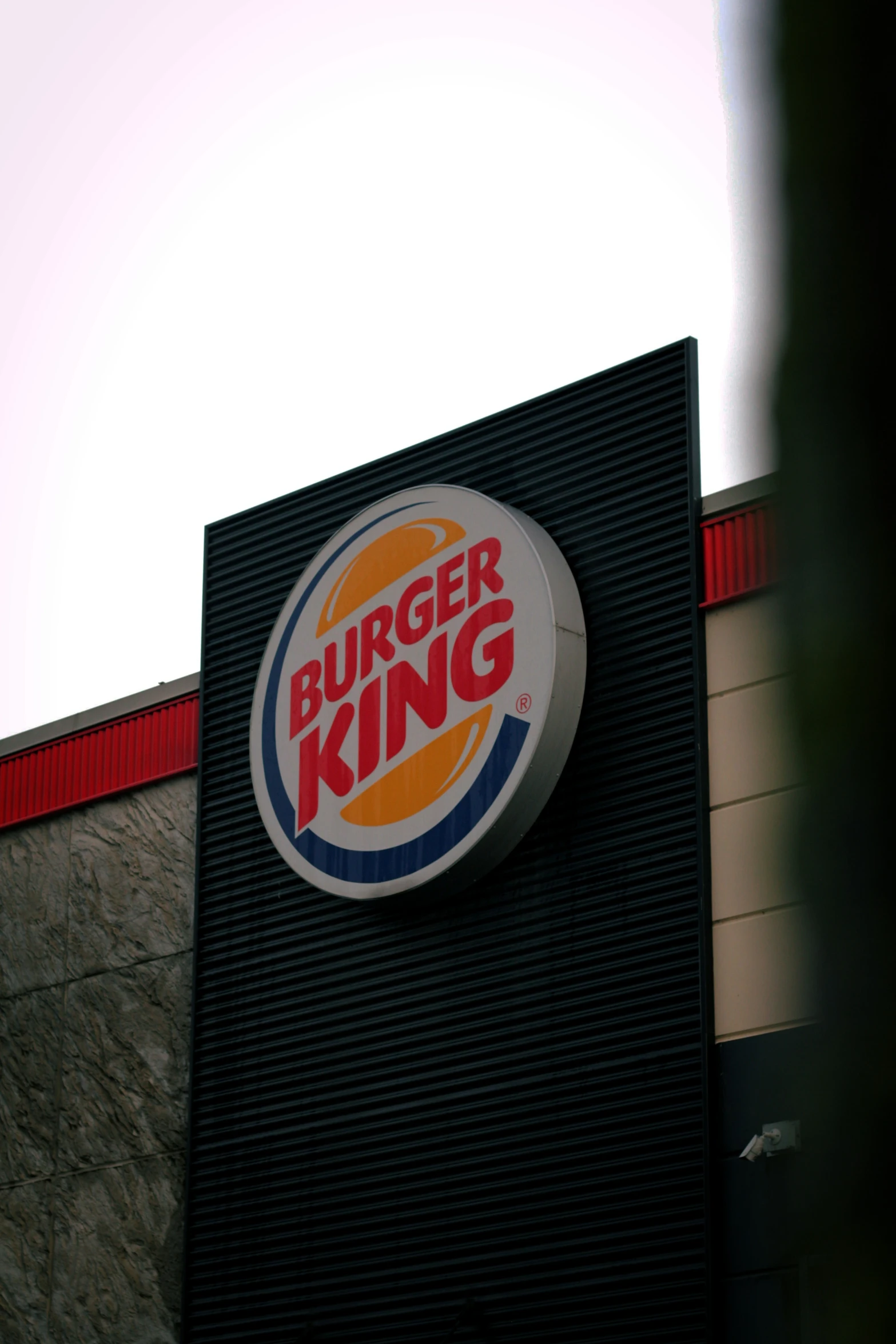 a burger king sign hanging off the side of a building