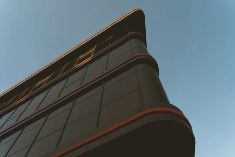 a tall black building with a red band on the top