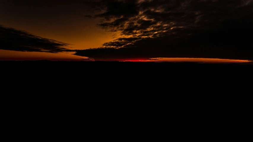 a plane flying high into the sky over the horizon