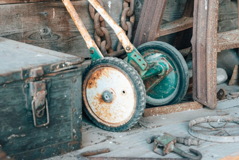 some old rusty machinery in front of a wood structure