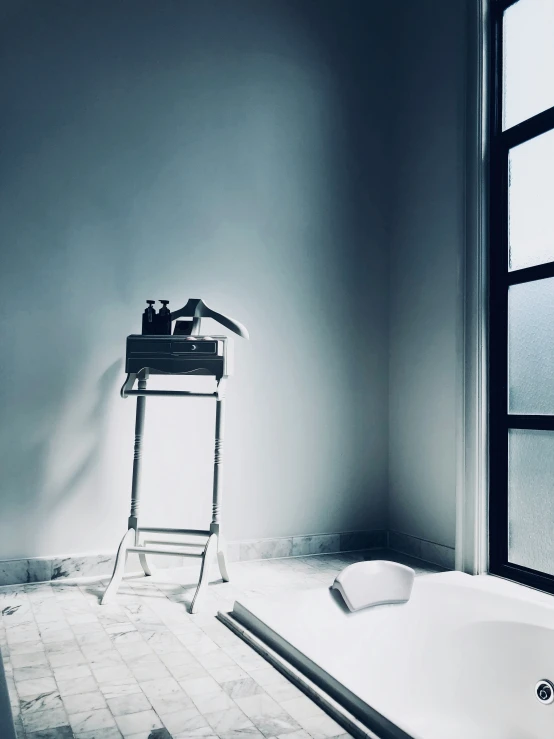 a white bath tub sitting next to a window in a bathroom